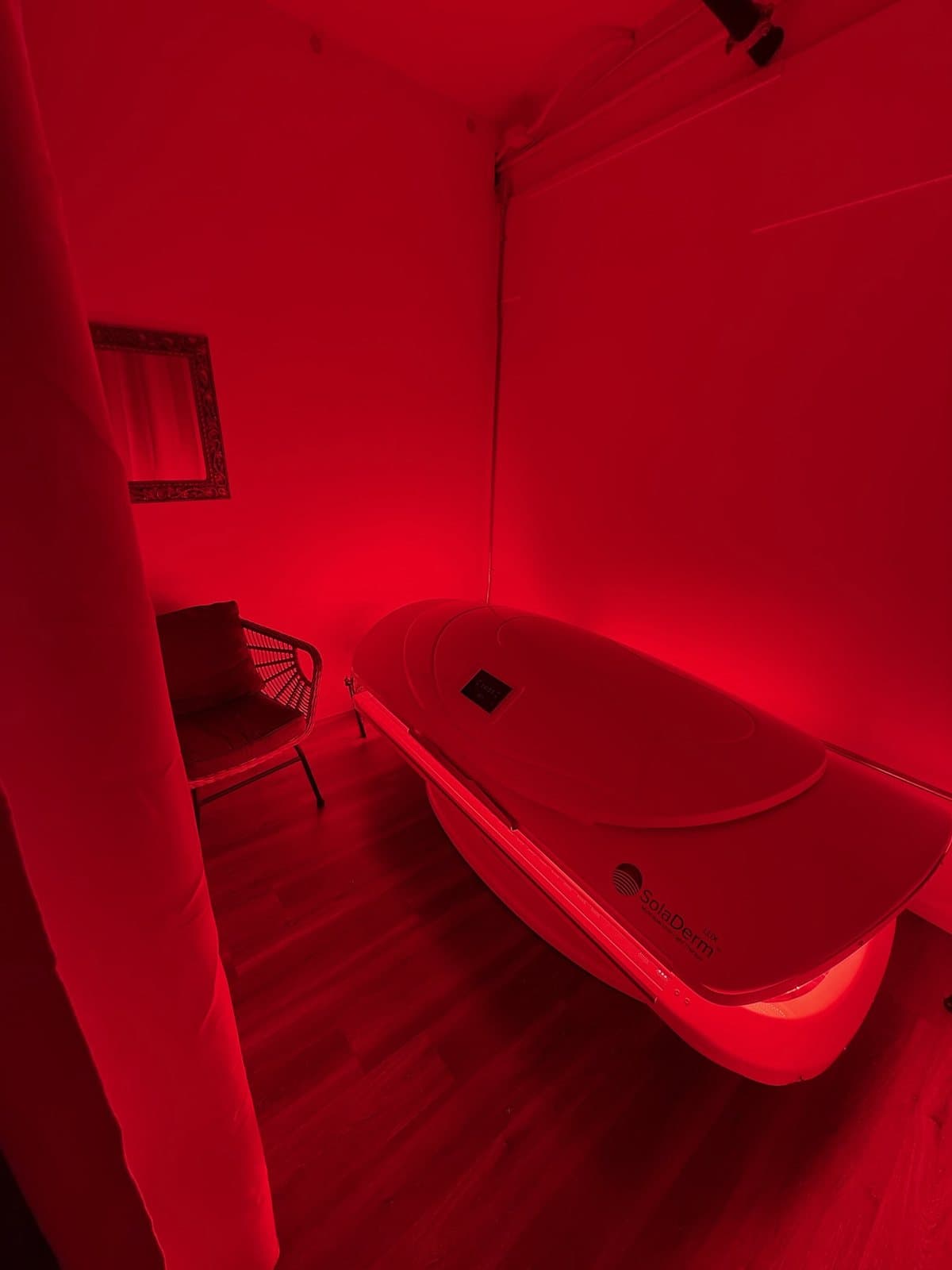 A therapy pod in a room lit entirely in deep red light